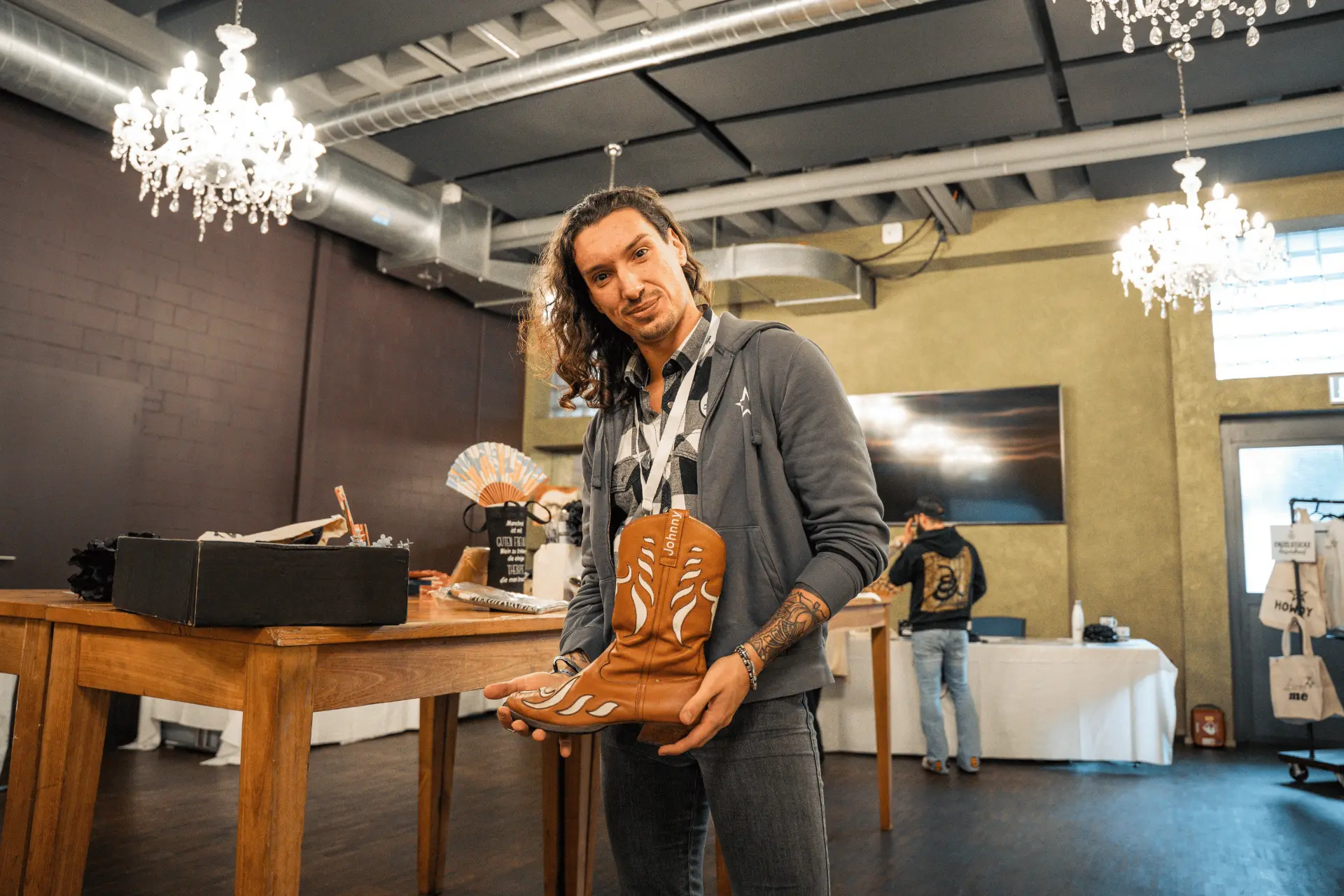 Johnny Rossato holding a custom Hanton Cavalier boot with his name embroidered on it